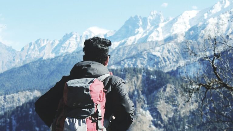 A backpacker looking at the snowy peaks around Shimla, Himachal Pradesh