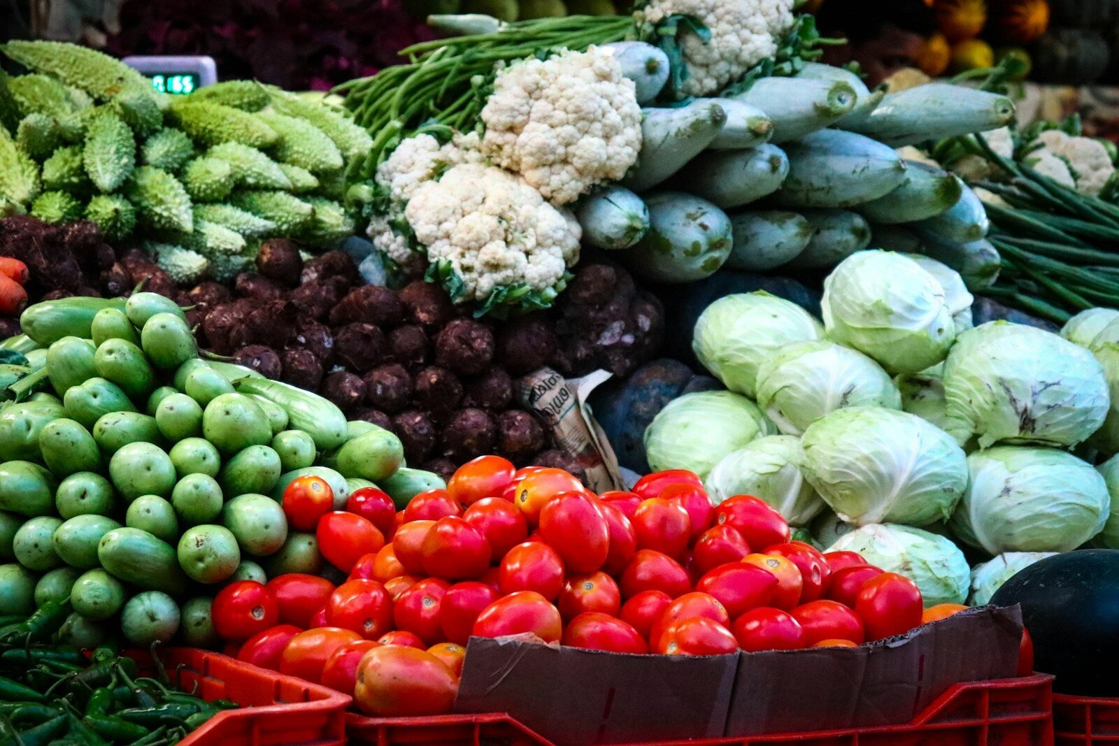 A pile of fresh vegetables in low light